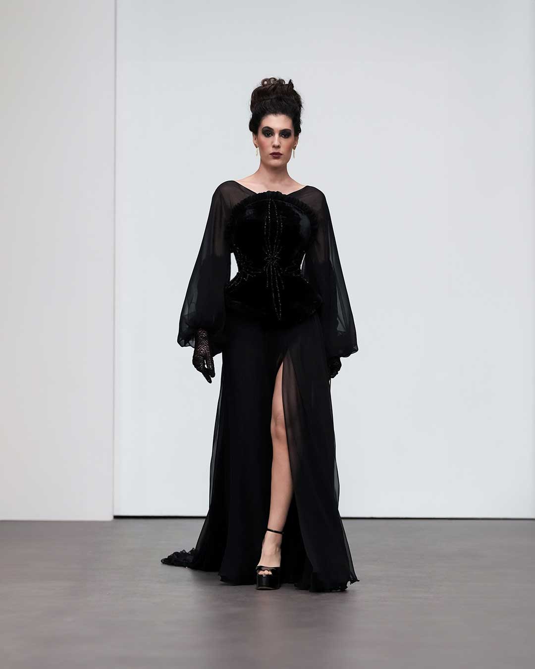 Elegant Black Velvet Gown with Sheer Sleeves and Thigh-High Slit – Designers & Us
